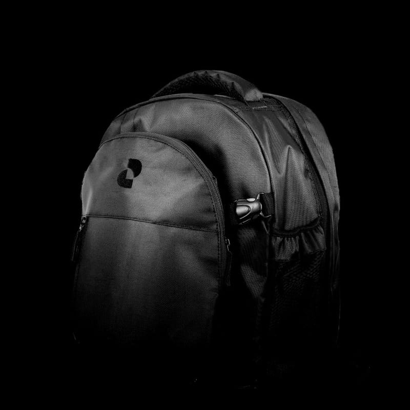 A black durable fabric backpack with multiple zippered compartments against a dark background.
